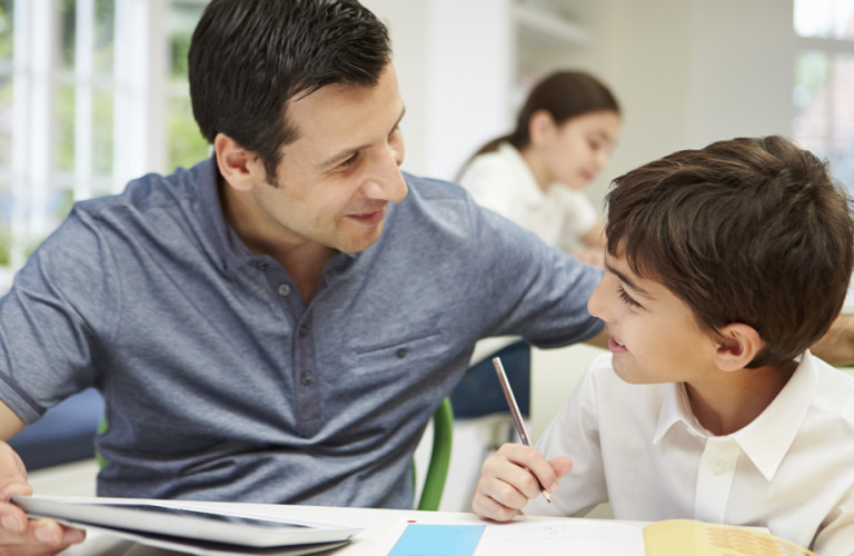 man and boy studying french at home