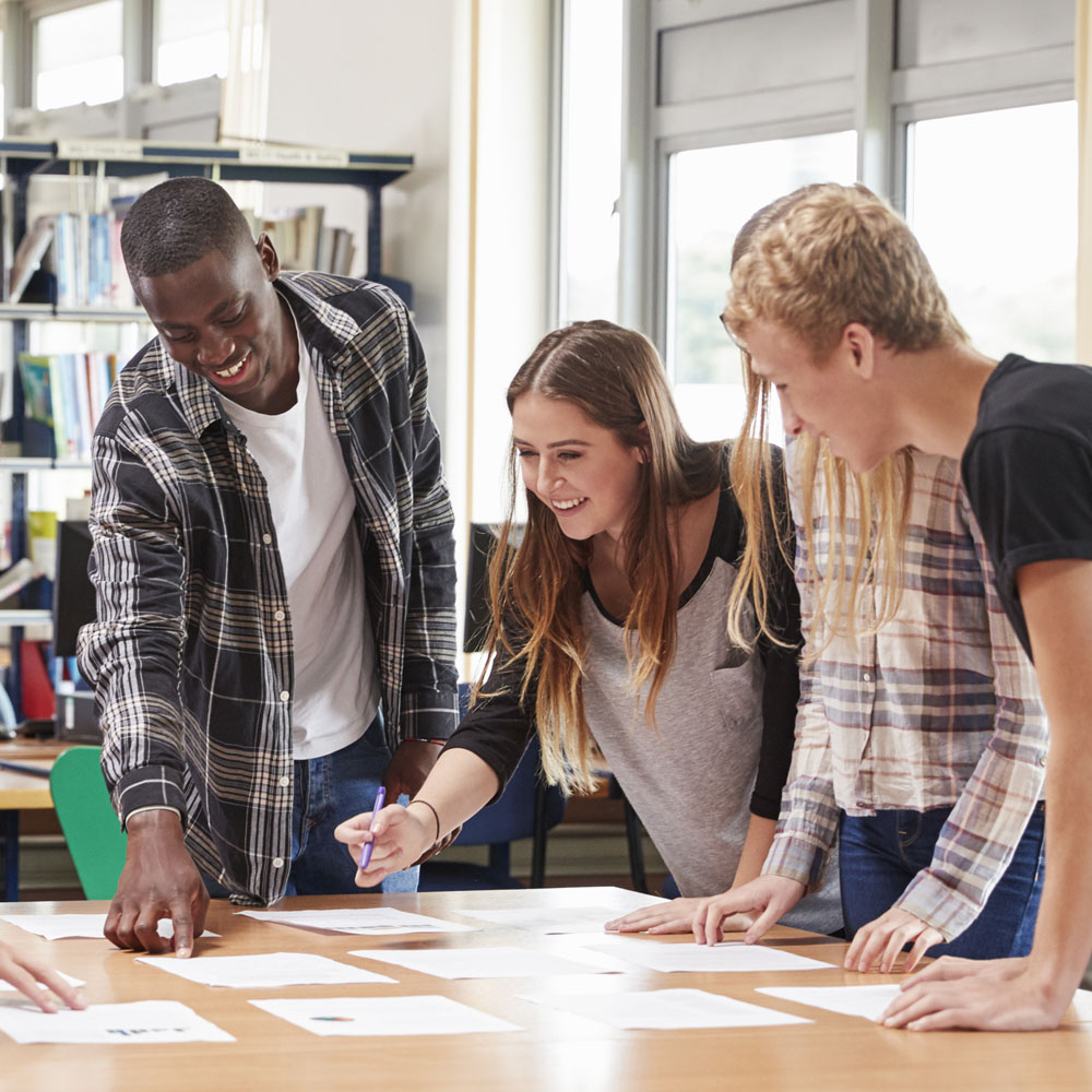 A group of high school students are working together in their teamwork group workshop.