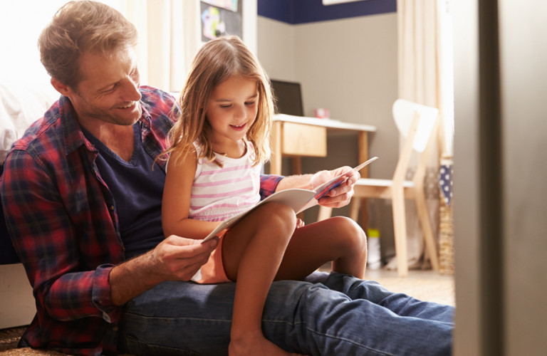 Father and daughter reading together