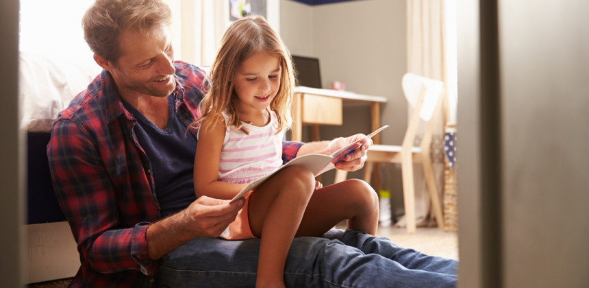 Father and daughter reading together