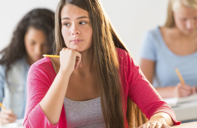 Student sitting in class thinking about math work